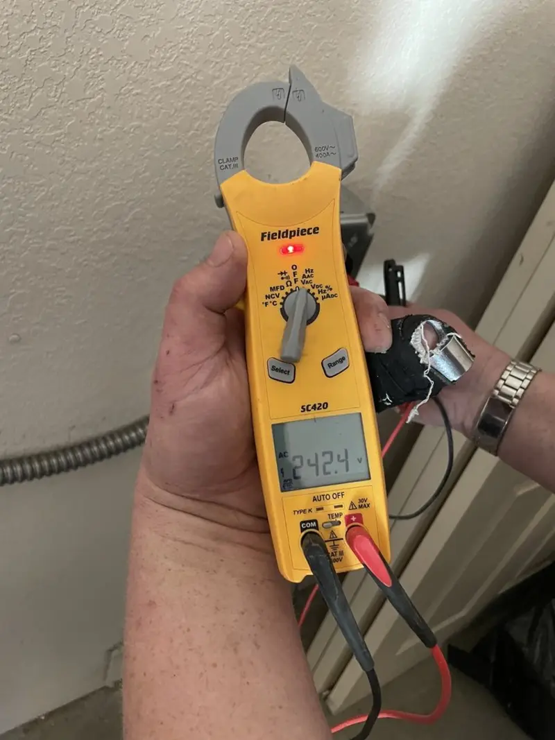 Voltage testing with clamp meter during Ceiling Fan Installation in Marinette